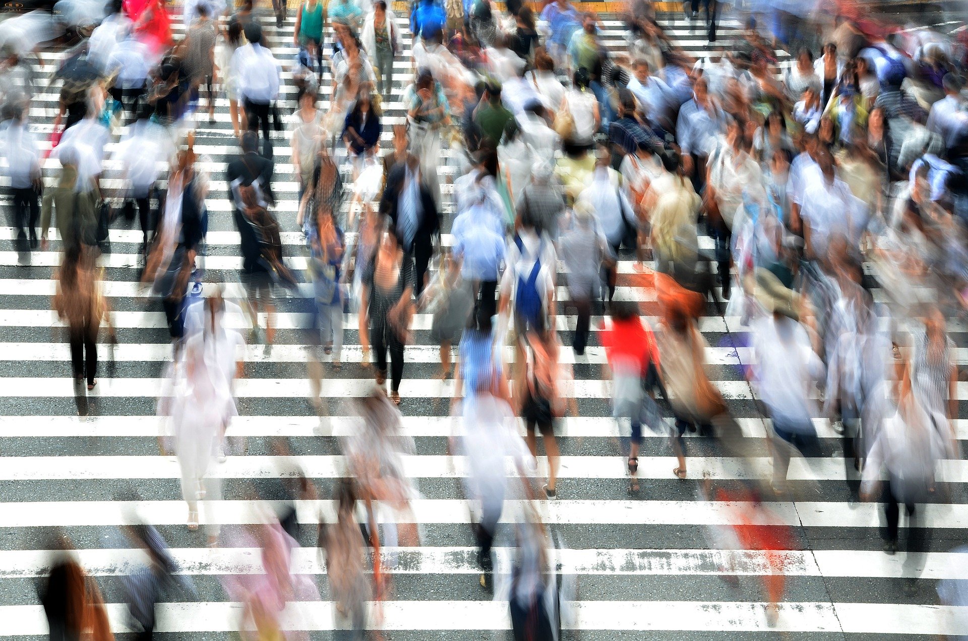 People crossing a busy pedestrian crossing